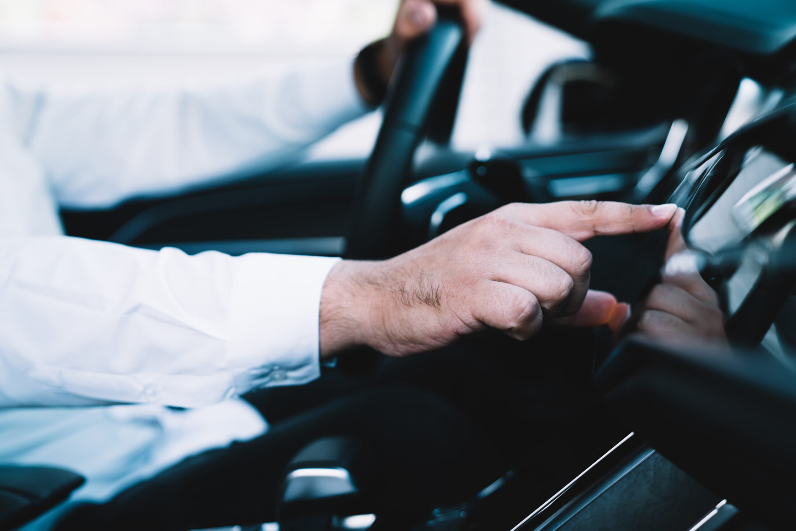 Man operates vehicle touchscreen whilst driving